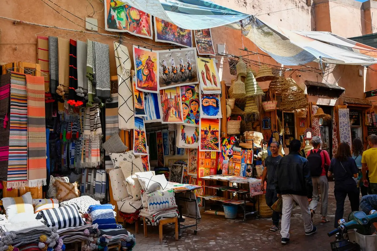 Narrow alleyway in the Marrakech medina souks lined with stalls