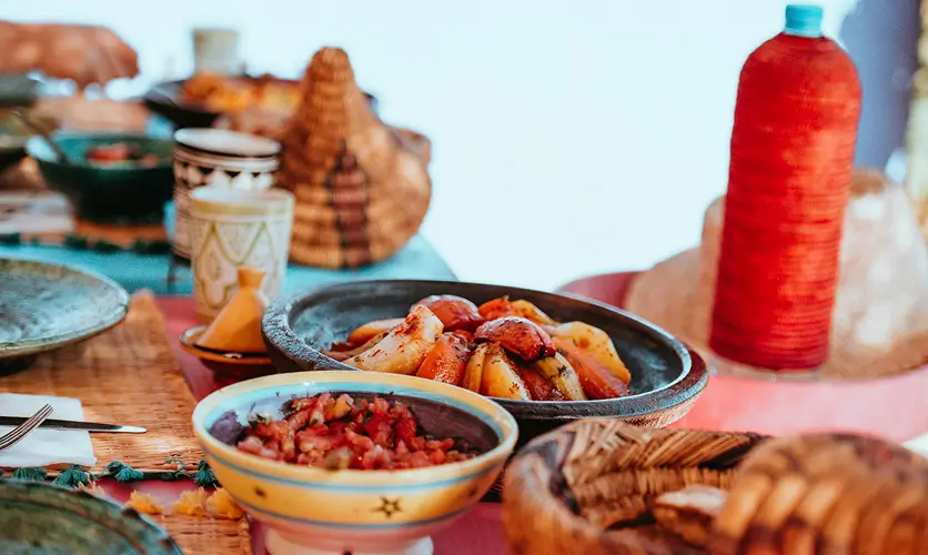 Moroccan tagine with bread and side dishes, a typical low-cost meal in Marrakech