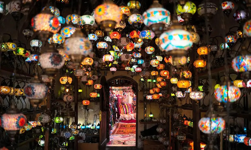 Copper and colored-glass lanterns for sale in a Marrakech souk, where haggling is expected