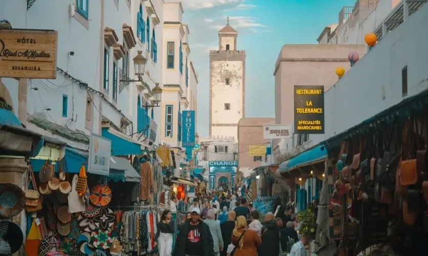 Busy market street with shops and stalls in the Essaouira medina